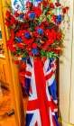 Colorful D-Day memorial flowers poppies, UK Flag, St. Saviours Church, Dartmouth, Devon, England. Art Print